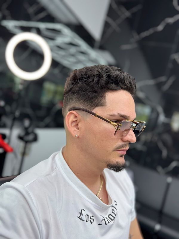Curly textured top with a low fade