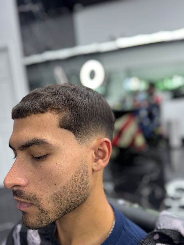 French crop with a low fade and beard