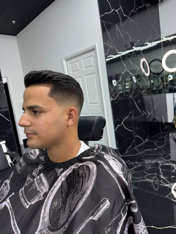 Slicked-back cut with a low fade